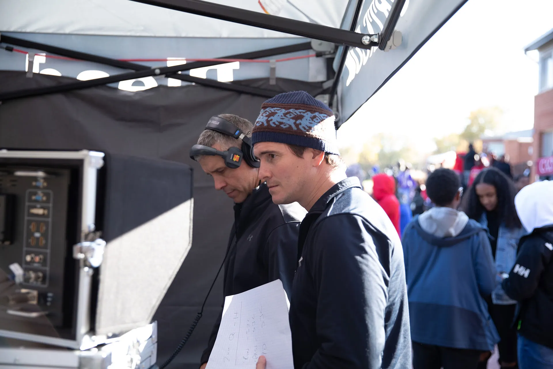 Commentators calling a game from the broadcast booth.