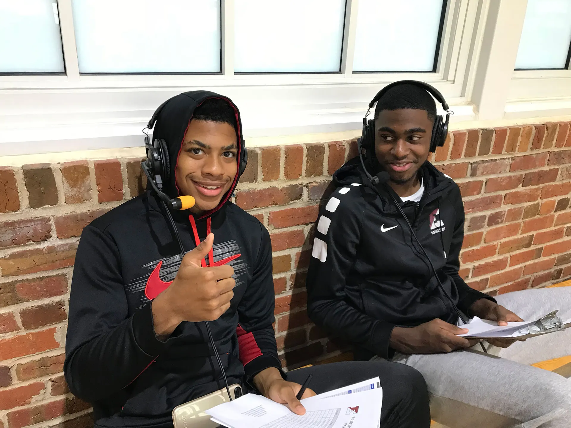Students operating a camera at a school sporting event.
