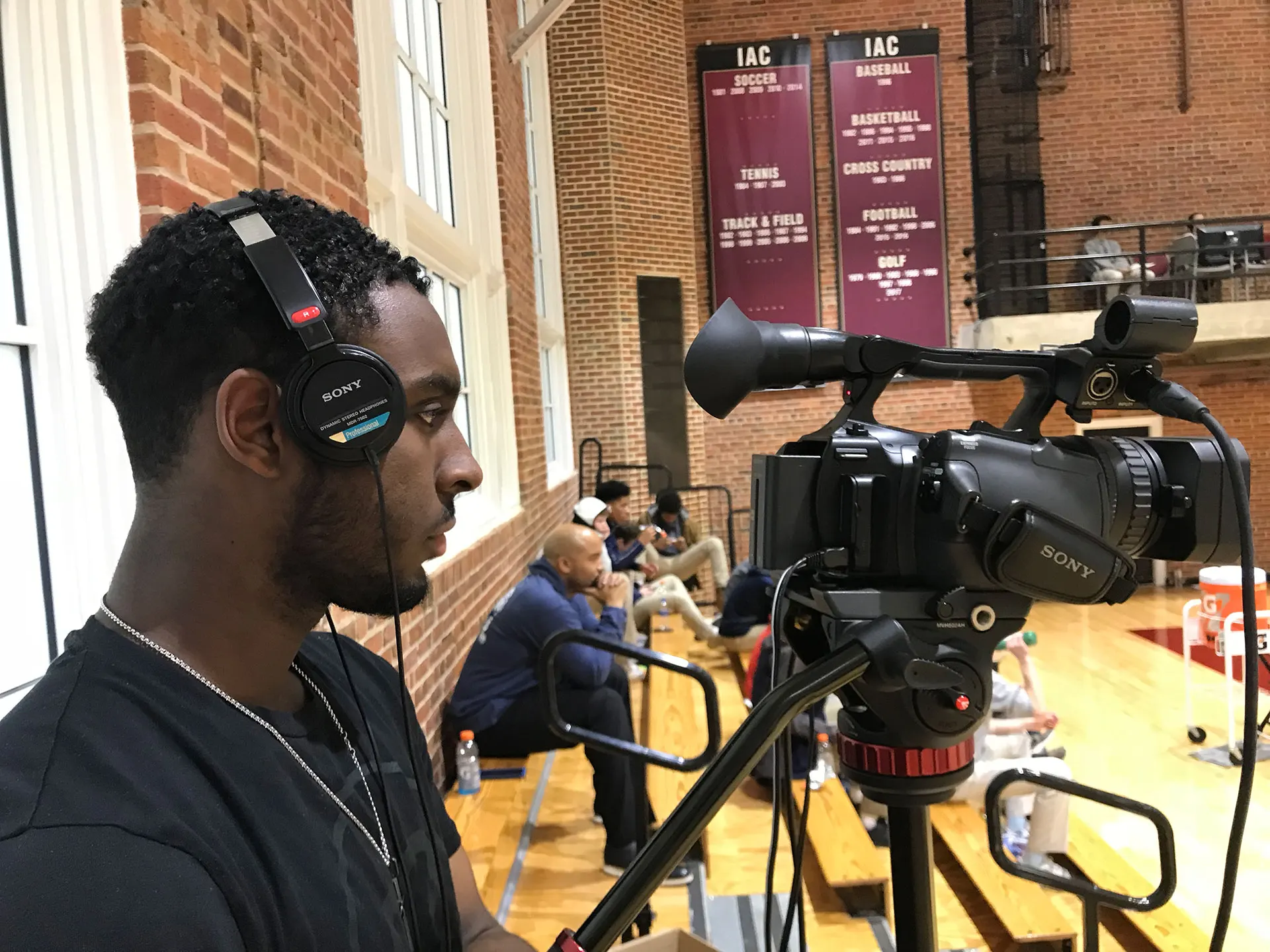 Students on headsets calling play-by-play for their school.